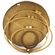 An assortment of craft equipment. Including embroidery hoops, a wicker tray, etc.