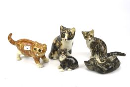 A collection of five assorted Winstanley pottery cats.