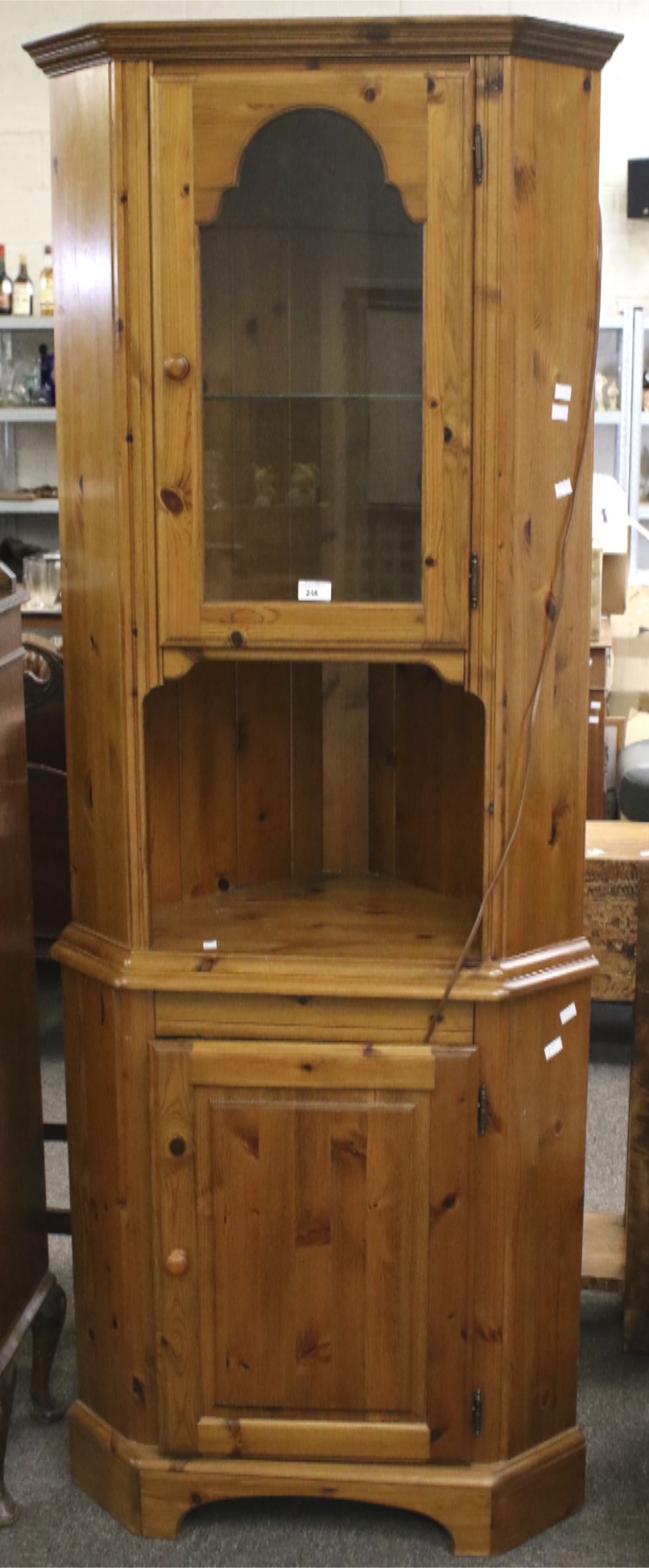 A contemporary pine corner cabinet. The