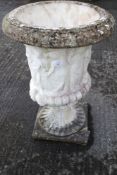 A large composite stone garden urn.