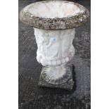 A large composite stone garden urn.