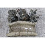 Four composite stone garden figures.
