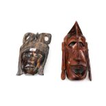 A West African carved ebony mask and an East African wooden mask. Max.