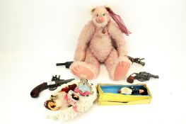 A collection of assorted toys. Including a 'Raspberry Sorbet' teddy bear, dolls, cap guns, etc.