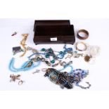 An Art Deco Bakelite jewellery box of assorted costume jewellery. Including necklaces, bangles, etc.