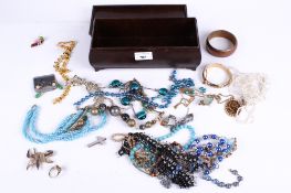An Art Deco Bakelite jewellery box of assorted costume jewellery. Including necklaces, bangles, etc.