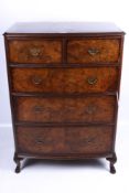 An early 20th century burr walnut bow fronted chest of drawers.