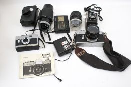 An assortment of vintage camera equipment and accessories.