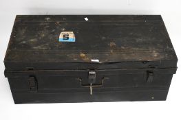 A vintage black japanned metal travelling trunk.