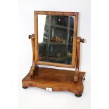 An Edwardian mahogany swing mirror/dressing table mirror. With serpentine base on turned feet.