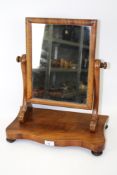 An Edwardian mahogany swing mirror/dressing table mirror. With serpentine base on turned feet.