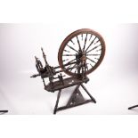 A vintage painted and turned spinning wheel.