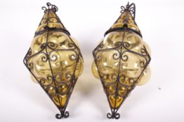 Vintage / Retro : A pair of vintage pendant hall lights of caged amber glass.