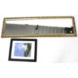 A full length bevel edged gilt wall mirror and a framed print.