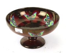 A red lustre butterfly bowl.