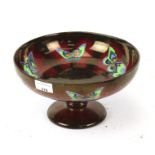 A red lustre butterfly bowl.