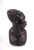 A carved ebonised wooden African bust of a female. H25.