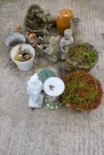An assortment of plant pots and garden ornaments. Including gnomes, a sundial, animals, etc.