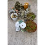 An assortment of plant pots and garden ornaments. Including gnomes, a sundial, animals, etc.