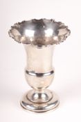 An Edwardian silver vase. Marked Birmingham 1902, with a fluted rim and circular base, H13.