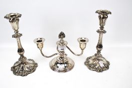 A pair of silverplated on copper candlesticks with shaped base and a short round two branch