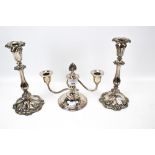 A pair of silverplated on copper candlesticks with shaped base and a short round two branch