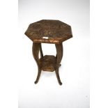 A carved wooden 'Liberty style' occasional table.