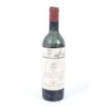 A bottle of vintage Chateau Mouton Rothschild 1955, numbered 107,982 (low neck).