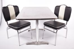 A retro aluminium top kitchen table and two chairs.