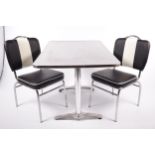 A retro aluminium top kitchen table and two chairs.