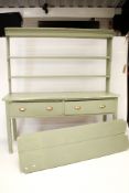 A vintage pine kitchen dresser, painted green. With two drawers beneath on square supports.