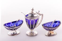 A silver plated wirework set consisting of a pair of salts and a mustard pot.