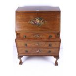 A Queen Ann style bureau on ball and claw feet. With three drawers beneath.
