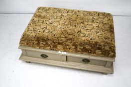 A North American painted square and upholstered ottoman with two drawers,