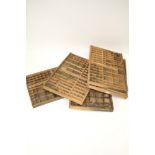 Five assorted vintage wooden printer's trays/drawers. Each drawer divided into smaller sections.