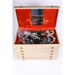 A large collection of assorted costume jewellery. In a cream case with five drawers.