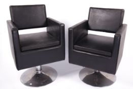 Vintage / Retro : A pair of Dir salon black leather swivel chairs. On a chrome circular base.