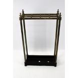 A vintage brass and cast iron stick umbrella stand.