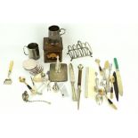 An assortment of silverplated items. Including a cigarette case, cutlery and cups, etc.