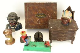 An assortment of cast iron money boxes and vintage tins.