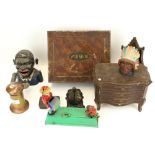 An assortment of cast iron money boxes and vintage tins.