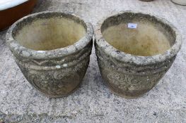 A pair of composite stone garden pots.