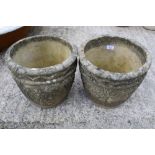 A pair of composite stone garden pots.
