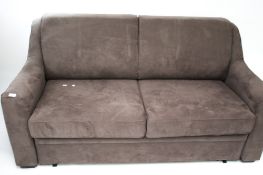 A contemporary grey suede upholstered two seater sofa bed.