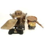 An assortment of metalware. Including a set of scales, a copper saucepan, twin handled pot, etc.