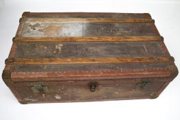 A vintage travelling trunk with metal lining.