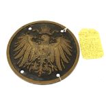 A Prussian bronze circular wall plaque. Showing a single Imperial eagle, with four bolt holes.