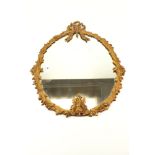 A gilt metal framed ribbon crested wall mirror.