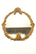 A gilt metal framed ribbon crested wall mirror.