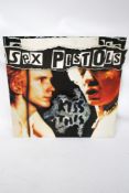Sex Pistols : A 1992 point of sale advertising board for 'Sex Pistols Kiss This'.